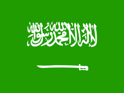 The Saudi flag has a white inscription in Arabic proclaiming Islam’s monotheism or shahada, “There is no god but Allah and Mohammed is the messenger of Allah.”