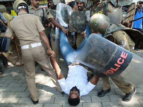 Police detain an activist amid demonstrations after women entered the Sabarimala temple, in Kochi in southern Kerala state, on January 4, 2019.