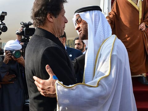 Imran Khan greets Mohammad Bin Zayed upon his arrival at the military Nur Khan Air Force base in Islamabad on January 6, 2019.