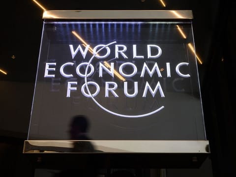 A man walks past a sign of the World Economic Forum (WEF) in Davos, eastern Switzerland