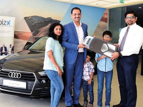 Renny Varghese is presented the Audi A4 car by Thomas Mathew, distrbution manager, Gulf News, at the Al Naboodah showroom.
