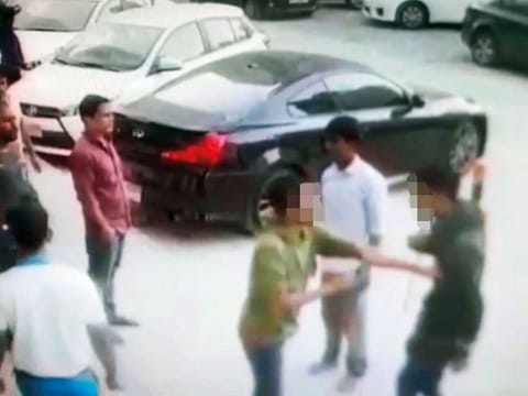 A video grab of the fake policeman (circled) being confronted by people in Sharjah’s Al Taawun area after the car-cleaner he tried to extort money from raised an alarm.