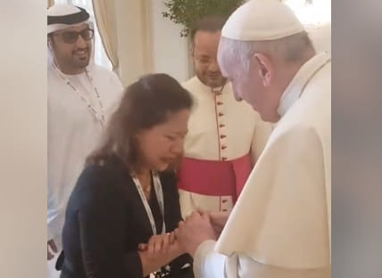 Filipina migrant worker Sally Mallari, a widow for 13 years, sobs during a brief encounter with Pope Francis in Abu Dhabi.