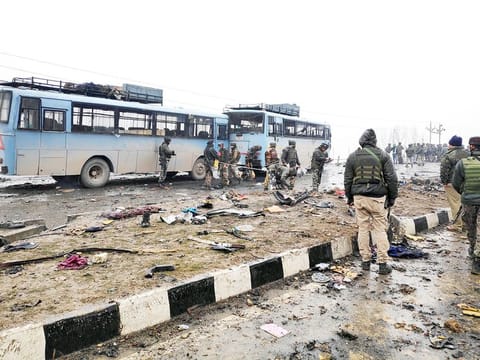 Indian soldiers examine the debris after an explosion in Lethpora in south Kashmir's Pulwama district.