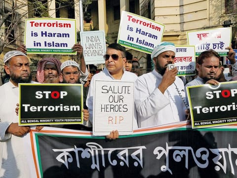 Muslims hold placards during a prayer meeting to pay tribute to Central Reserve Police Force (CRPF) personnel who were killed after a suicide bomber rammed a car into the bus carrying them in south Kashmir last week, outside a mosque in Kolkata, India.