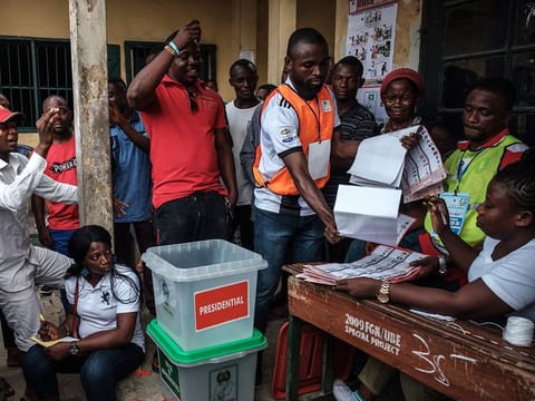 Officials count votes in front of voters during the presidential and parliamentary elections on February 23, 2019, at a polling station in Port Harcourt, southern Nigeria.