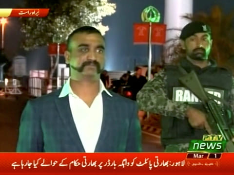 Indian pilot, Wing Commander Abhinandan, stands under armed escort near Pakistan-India border in Wagah, Pakistan in this March 1, 2019 image from a video footage.
