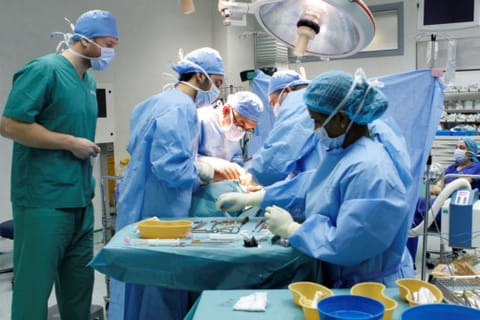 Doctors during the surgery on the 17-year-old girl. They first placed a surgical guide to ensure precision during drilling and cutting, before fitting 3D-printed patient-specific implant.
