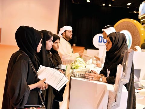 People gather to apply for Governement jobs at the Dubai Government Human Resource Department stand at the UAE Career Fair at DWTC.
