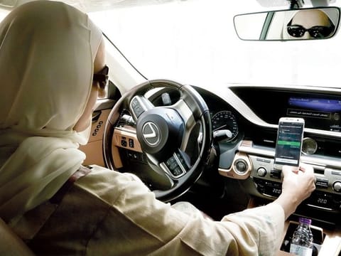 A Careem driver opens the Careem app on her mobile phone before she starts driving in Riyadh, Saudi Arabia. Uber announced yesterday it has acquired Careem for $3.1 billion.
