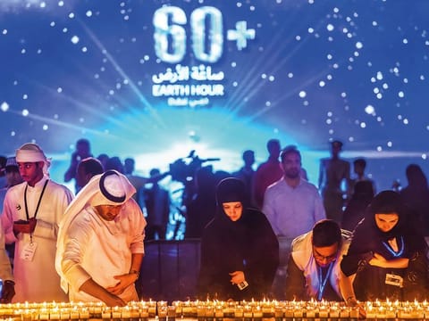 Residents light candles to mark Earth Hour 2019 at Marasi Marina in Business Bay, Dubai.