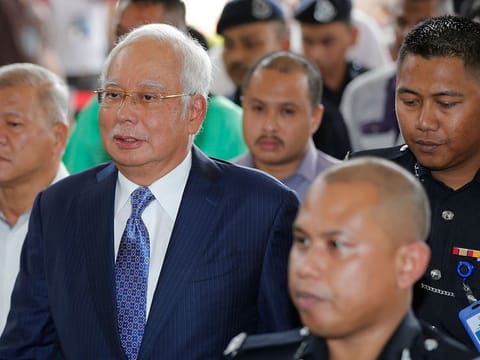 Former Malaysian Prime Minister Najib Razak, center, walks into a courtroom at Kuala Lumpur High Court in Kuala Lumpur, Malaysia, Wednesday, April 3, 2019.
