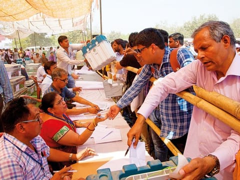 Polling officers collect election material in Ghaziabad, near New Delhi