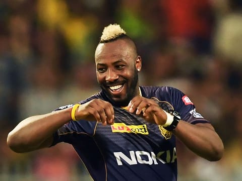 Andre Russell celebrates after taking the wicket of Evin Lewis.