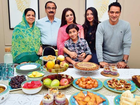 From left: Nadira Ahmad, M.K. Ahmad, Shijna, Zain, Tanaaz and Sajith Ansar get ready to enjoy a nutrient-packed Indian iftar at their villa at Mudon.