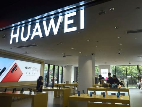 Shoppers browse smartphones at a Huawei retail store in Hangzhou in eastern China's Zhejiang province.