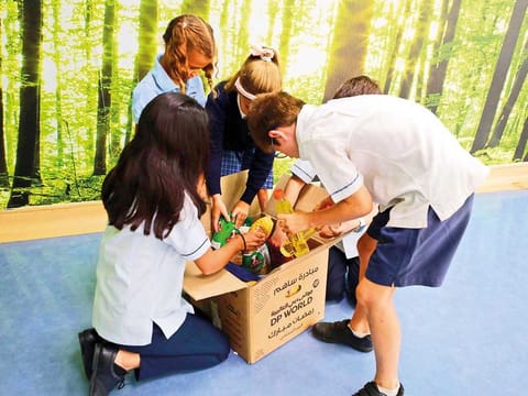 KG to Secondary students of Uptown School, Dubai, filling boxes with donated items for the Ramadan Box Project.