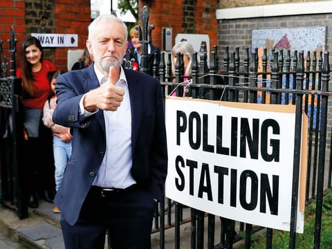 Britain's Labour Party leader Jeremy Corbyn gestures after voting at a local polling station in his constituency in London, Britain.