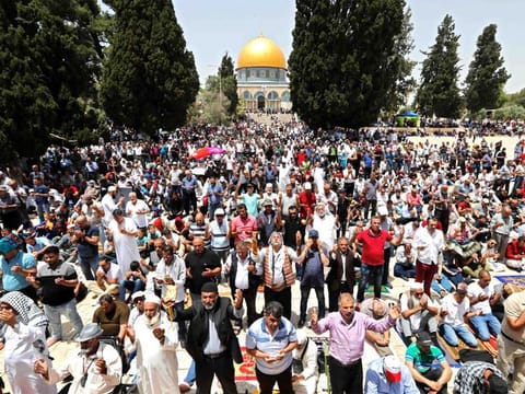 Palestinians pray in front of the Dome of the Rock mosque in the Al Aqsa Mosque compound in Jerusalem.
