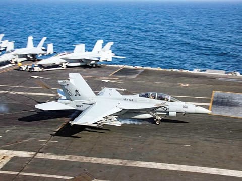 An F/A-18F Super Hornet makes an arrested landing on the aircraft carrier USS Abraham Lincoln in the Gulf of Oman