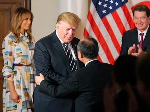 US President Donald Trump, center left, greets SoftBank Group Corp.'s Chief Executive Masayoshi Son, center right, as first lady Melania Trump, left, and U.S. Ambassador to Japan William Hagerty looks on during his meeting with business leaders, in Tokyo, Saturday, May 25, 2019. President Trump is on a four-day state visit in Japan.