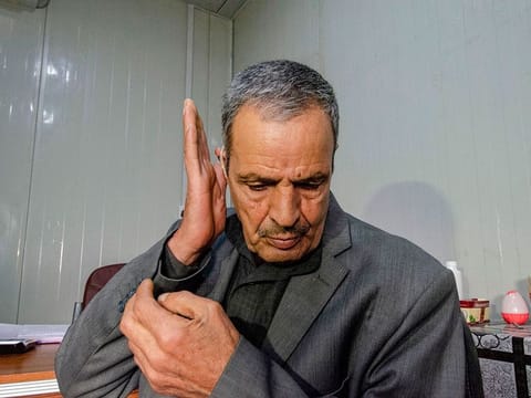 An Iraqi deaf patient tests his hearing aid at Jumhuri hospital, a specialised hearing impairment centre, in west Iraq's city Mosul on February 24, 2019.