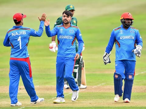 Afghanistan's Rashid Khan (C) celebrates with team mates after taking the wicket of Pakistan's captain Sarfaraz Ahmed during the 2019 Cricket World Cup warm up match between them at Bristol County Ground in Bristol, southwest England, on May 24, 2019.