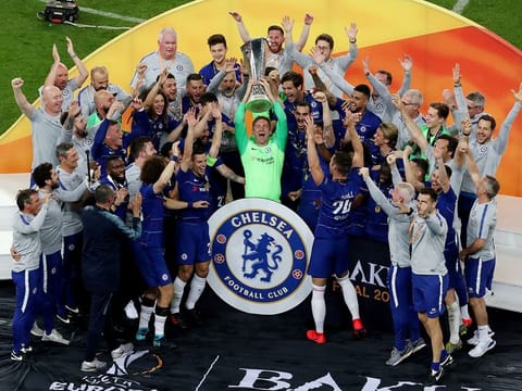 Chelsea celebrate winning the Europa League with the trophy.