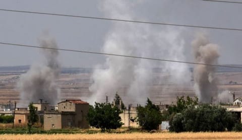 Smoke billows above buildings as pro-regime forces pound the village of Tal Meleh with tank and aerial fire during clashes between the two rival sides in Syria's Hama governorate on June 9, 2019.