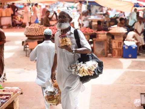 A vendor sells dry fruits at a market in Karachi.