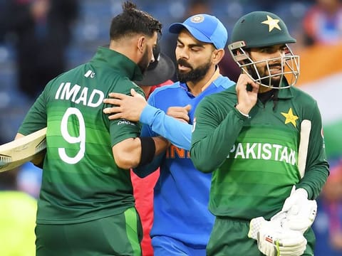India's captain Virat Kohli (C) embraces Pakistan's Imad Wasim (left) after their victory.