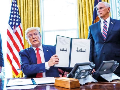 Trump, flanked by Mike Pence (right) and Steven Mnuchin at the White House signs ‘hard-hitting sanctions’ on Iran’s supreme leader.