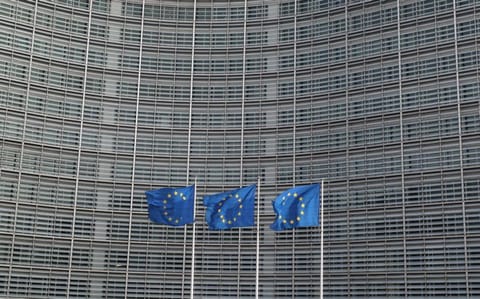 European Union flags fly outside the European Commission headquarters in Brussels, Belgium.