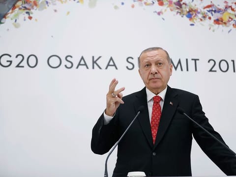 Turkey's President Recep Tayyip Erdogan talks to members of the media during a news conference following the G-20 summit in Osaka, Japan.