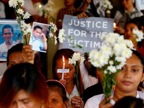In this March 17, 2019, file photo, relatives of victims in President Rodrigo Duterte's so-called war on drugs hold a memorial for their loved ones at a church in Manila, Philippines.