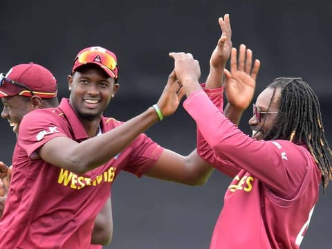 West Indies' Chris Gayle (R) celebrates with West Indies' Carlos Brathwaite the wicket of Afghanistan's Ikram Alikhil for 86 during the 2019 Cricket World Cup group stage match between Afghanistan and West Indies at Headingley in Leeds, northern England, on July 4, 2019.