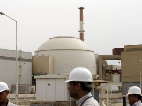In this file photo taken on February 25, 2009, Iranian technicians walking outside the building housing the reactor of the Bushehr nuclear power plant, in the Iranian port town of Bushehr, 1200 kms south of Tehran.