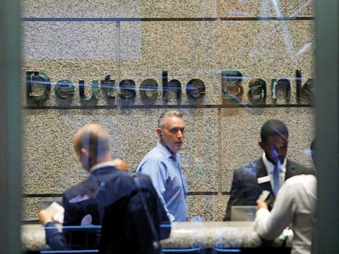 People are seen in the lobby of the US headquarters of Deutsche Bank in New York City.