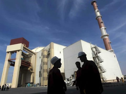 File photo of Iranian workers standing in front of Bushehr nuclear power plant
