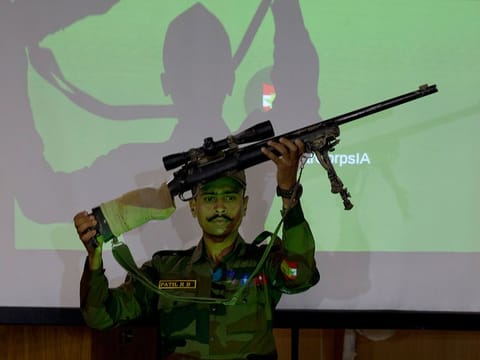 An Indian army officer displays a sniper gun recovered during a search operation along the Amarnath route, during a joint press conference in Srinagar, Indian controlled Kashmir, Friday, Aug. 2, 2019.