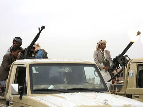 A Houthi fighter fires in the air during a gathering aimed at mobilising more fighters for the their movement, in Sanaa, Yemen.