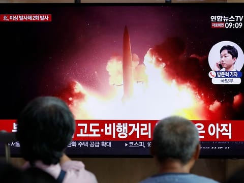 People watch a TV news program reporting about North Korea's firing projectiles with a file image at the Seoul Railway Station in Seoul, South Korea, Friday, Aug. 16, 2019.