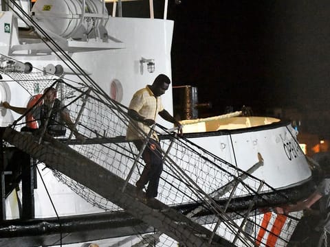 A man disembarks from the Open Arms rescue ship on the Sicilian island of Lampedusa, southern Italy, Tuesday, Aug. 20, 2019.