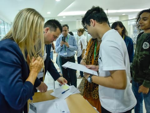 Students and parents at GEMS Wellington International School in Dubai on Thursday.