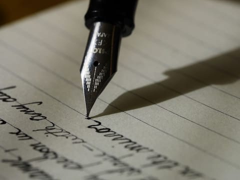 Writing with an ink pen. For illustrative purposes only.