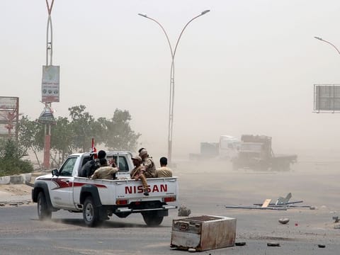 Members of Southern Transitional Council (STC) forces patrol a road during clashes with government forces in Aden, Yemen
