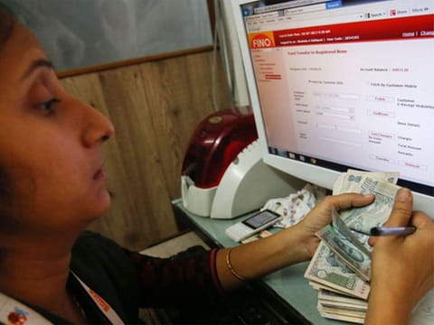 A teller counts a bundle of Indian Rupee currency notes. Optimism over the development of Covid-19 vaccine along with broad-based growth trends is expected to induce volatility in the rupee’s value during the short term.
