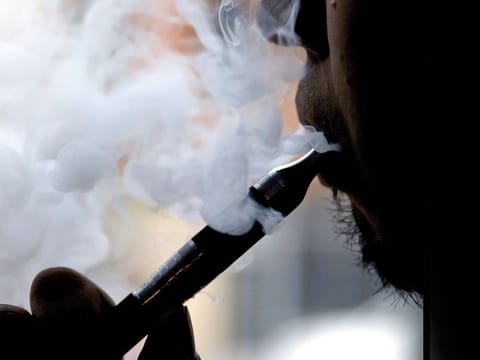 A man smokes an electronic cigarette.