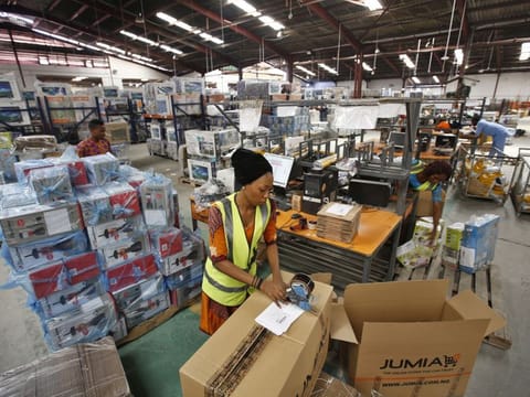Bloomberg
A worker packages goods inside branded cardboard boxes inside a Jumia distribution warehouse in Lagos.