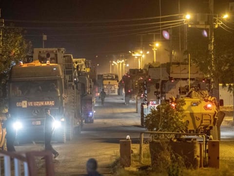 Turkish army soldiers drive towards the border with Syria near Akcakale in Sanliurfa province on Tuesday.
